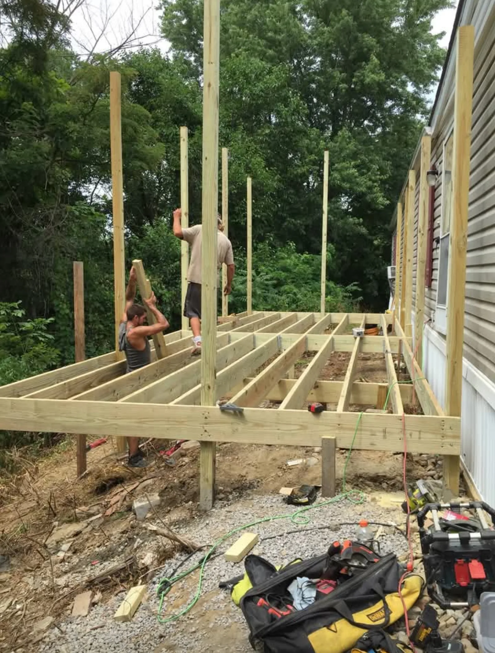 Raised deck framing erected for new backyard deck construction
